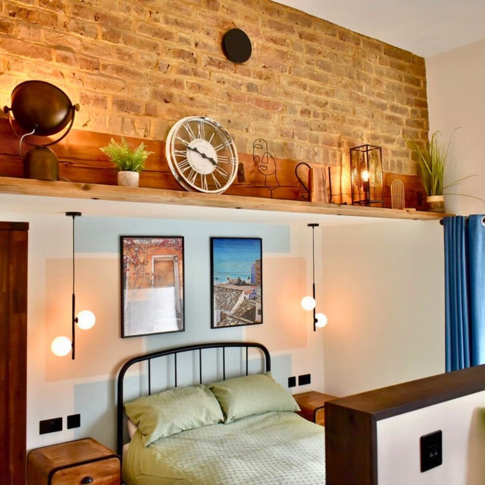 Pendant lights over nightstands in Surbiton bedroom
